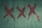 Cross mark red symbol on green wal.