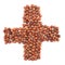 Cross plus shape made of hazelnuts isolated