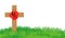 Cross with red poppies on a green lawn