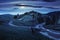 Cross road on hillside meadow in mountain at night