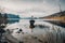 Cross on rock in lake Mond surrounded mountains