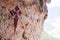 Cross of Santiago in red paint on a rock in a religious cave