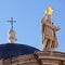 A cross and sclupture on the Church of St. Blasius