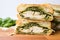 cross-section view of a stacked chicken pesto sandwich