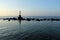 Cross shaped cairn, landmark or milestone made of concrete in middle of the sea