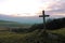 A Cross shaped Sign Post in a Field