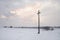 Cross in snow during sunset