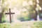 The cross standing on meadow sunset and bokeh background