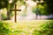 The cross standing on meadow sunset and bokeh background