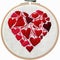 A cross stitched heart with red hearts on it, embroidery on white background