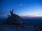 Cross summit and moon at sunset, mount Acuto, Apennines, Marche, italy