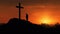 Cross in sunset and lone silhouetted person praying