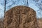 Cross symbol chiseled on a gravestone in sunlight