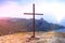 Cross on top of the mountain close-up. Religious symbol on the background of the Crimean mountains. Big Catholic wooden cross in