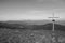 Cross on the top of mountains black and white. Faith and memory sign.Christian religion symbol monochrome. Road to nowhere.