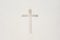 Cross in a white wall. Religious symbol