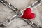 Crossed chains with red heart