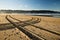 crossed engine tyre trace track on a sandy beach in hendaye