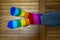 Crossed feet with pride socks on a wooden background