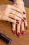 Crossed female hands with decorative manicure