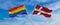 crossed flags of lgbt and denmark flag waving in the wind at cloudy sky. Freedom and love concept. Pride month. activism,