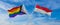 crossed flags of progress lgbt pride and Luxembourg flag waving in the wind at cloudy sky. Freedom and love concept. Pride month.