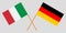 The crossed Germany and Italy flags. Official colors. Proportion correctly. Vector
