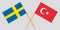 The crossed Turkey and Sweden flags. Official colors. Vector