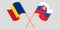 Crossed and waving flags of Romania and Slovakia