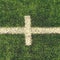 Crossed white lines on outdoor football playground. Detail of lines in a soccer field. Plastic grass and finely ground b