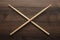 Crossed wooden drumsticks on wooden table