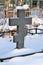 Crosses in a cemetery, monuments of the dead, a cemetery in winter, wreaths, artificial flowers. Russia