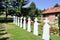 Crosses in cemetery. White gravestones going in perspective