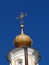 The crosses on the top of the church are of the original form. A star is slightly visible above the cross. Blue sky.