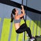 Crossfit rope climb exercise in fitness gym