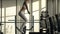 Crossfit woman jumping on platform on fitness training in gym club