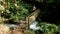 Crossing Bamboo Bridge over the River in Tropical Rainforest Jungle. 4K motion Wide Angle POV Natural Footage. Bali