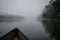 Crossing the Moa river by canoe to Tiwai Island Wildlife Sanctuary during foggy early morning, Sierra Leone, Africa