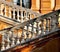 Crossing ornate balustrades and orange building