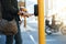 Crossing safely. an unrecognizable man pressing the crosswalk button on a traffic light while traveling through the city