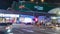 Crossroads in the center of night Kuala Lumpur. Timelapse of the movement of people, cars, trains. Malaysia, April, 2023