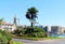 Crossroads with a palm tree and flowers and signposts in the French seaside town of Sete.