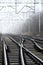 Crossroads of railway tracks in the fog