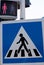 Crosswalk road sign. Pedestrian crossing sign and traffic light for pedestrians. Red light no passage. Standing man