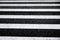 Crosswalk surface background,top view. pedestrian crossing, white stripes on black asphalt, zebra crossing