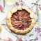 Crostata pie with cheese, figs, honey and thyme on grey background