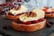 Crostini with cranberry sauce, apples, brie and pecans on slate