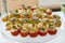 Crostini with different toppings on wooden background. Delicious appetizers. Front view. Gourmet appetizers: caviar, venison, tuna