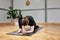 crouched woman with no recognizable face practicing yoga