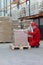 Crouching worker wrapping box on pallet